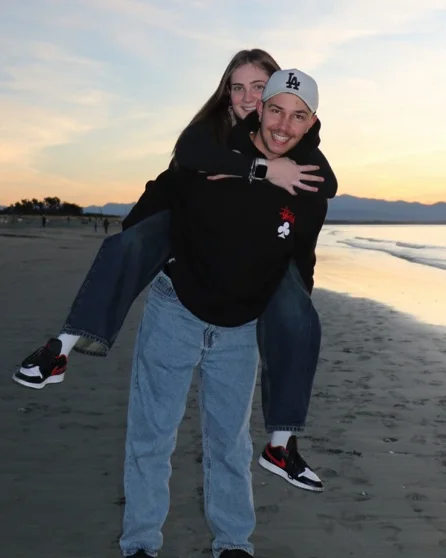 Daniel and Caitlyn Gallagher on a beach at sunset