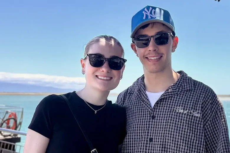 Daniel and Caitlyn Gallagher on the waterfront at Rocks Road, Nelson, with the harbour behind them